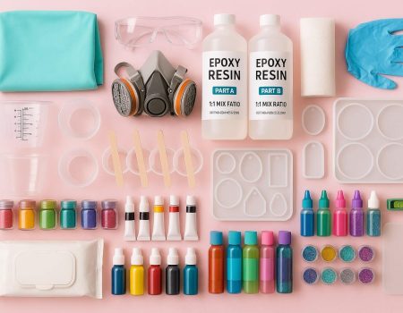 Essential resin art materials for beginners, including epoxy resin, molds, colorants, safety gear, and tools.